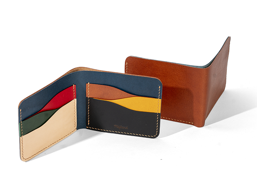 the wallet open showing the different colored card pockets inside and another wallet next to it facing the other way, showing the brown outside