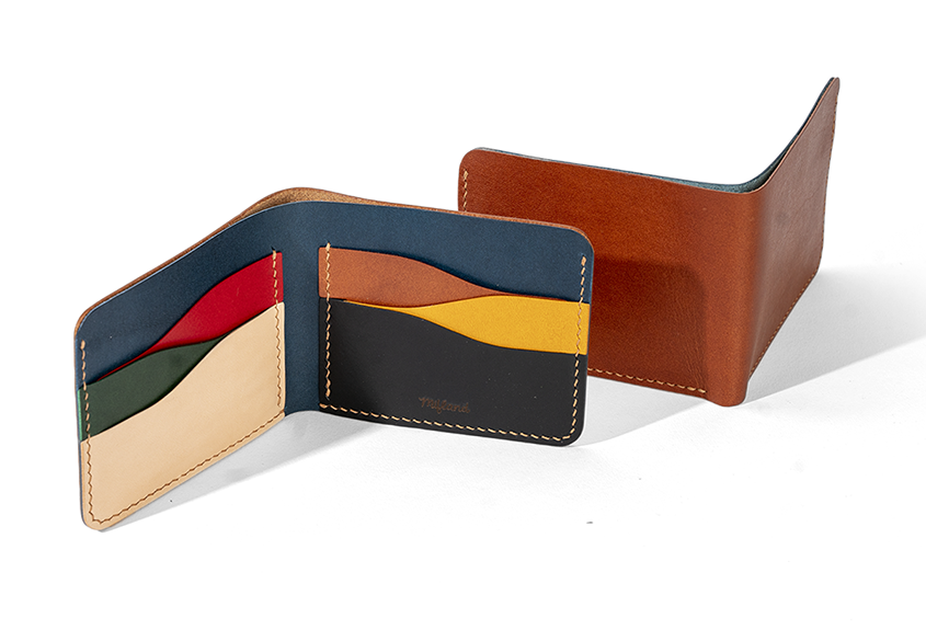 the wallet open showing the different colored card pockets inside and another wallet next to it facing the other way, showing the brown outside