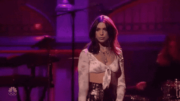 Dua lipa flipping hair and doing a confident strut while performing on SNL