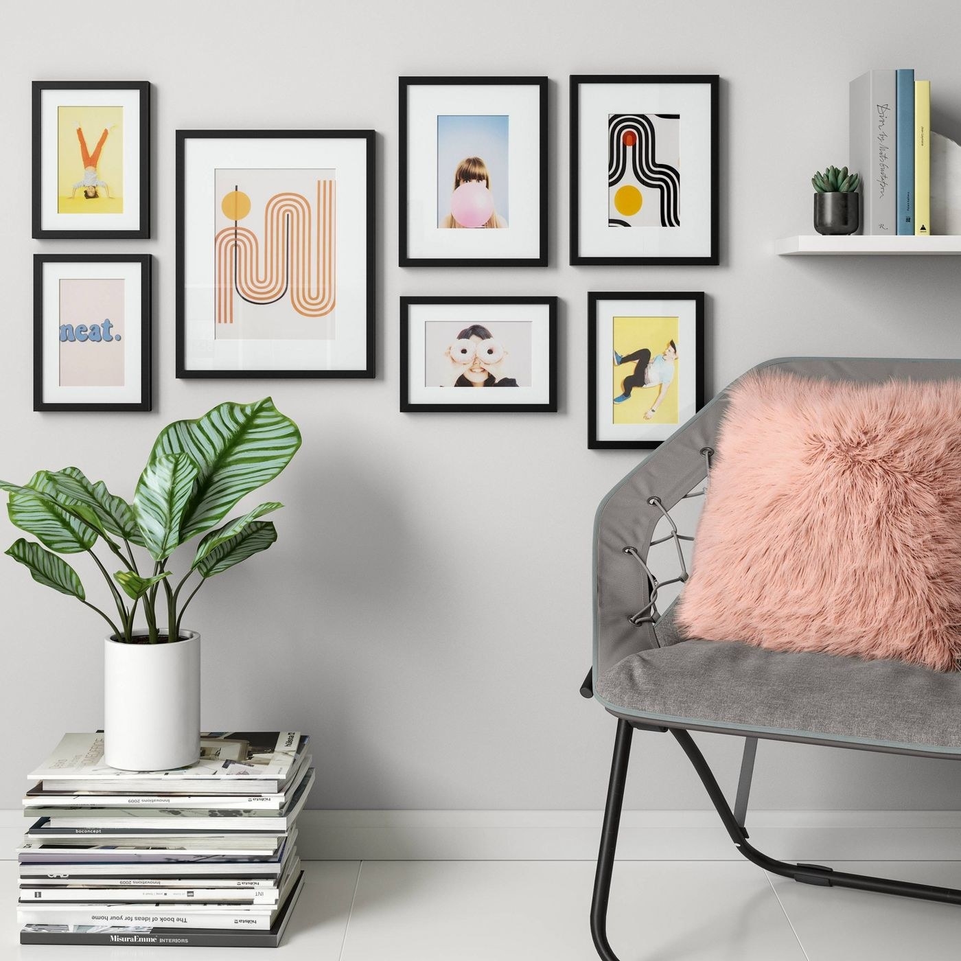 seven black frames hanging on the wall with photos and prints in them