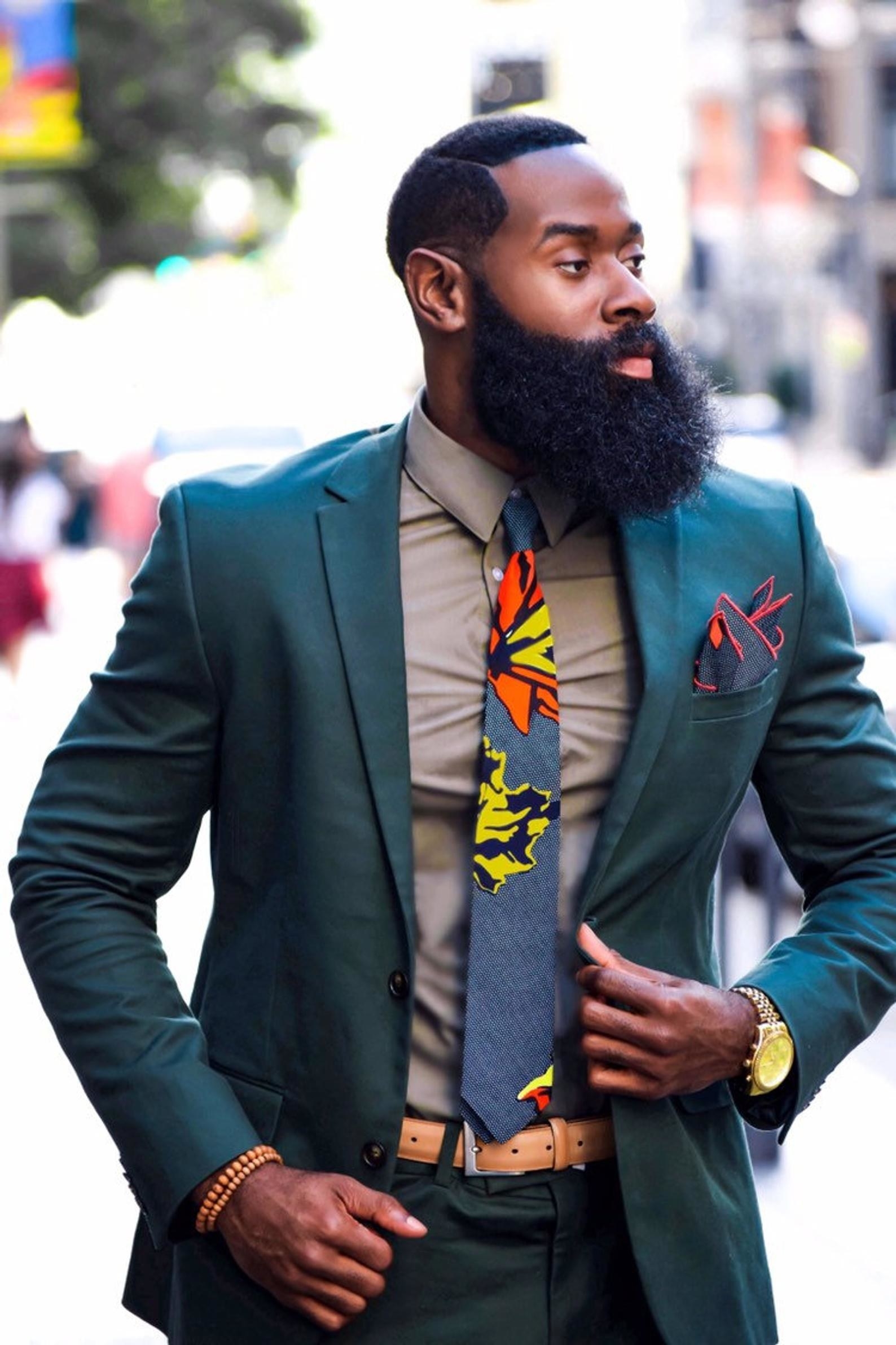 model wearing the skinny tie in grey with yellow and orange flowers on it
