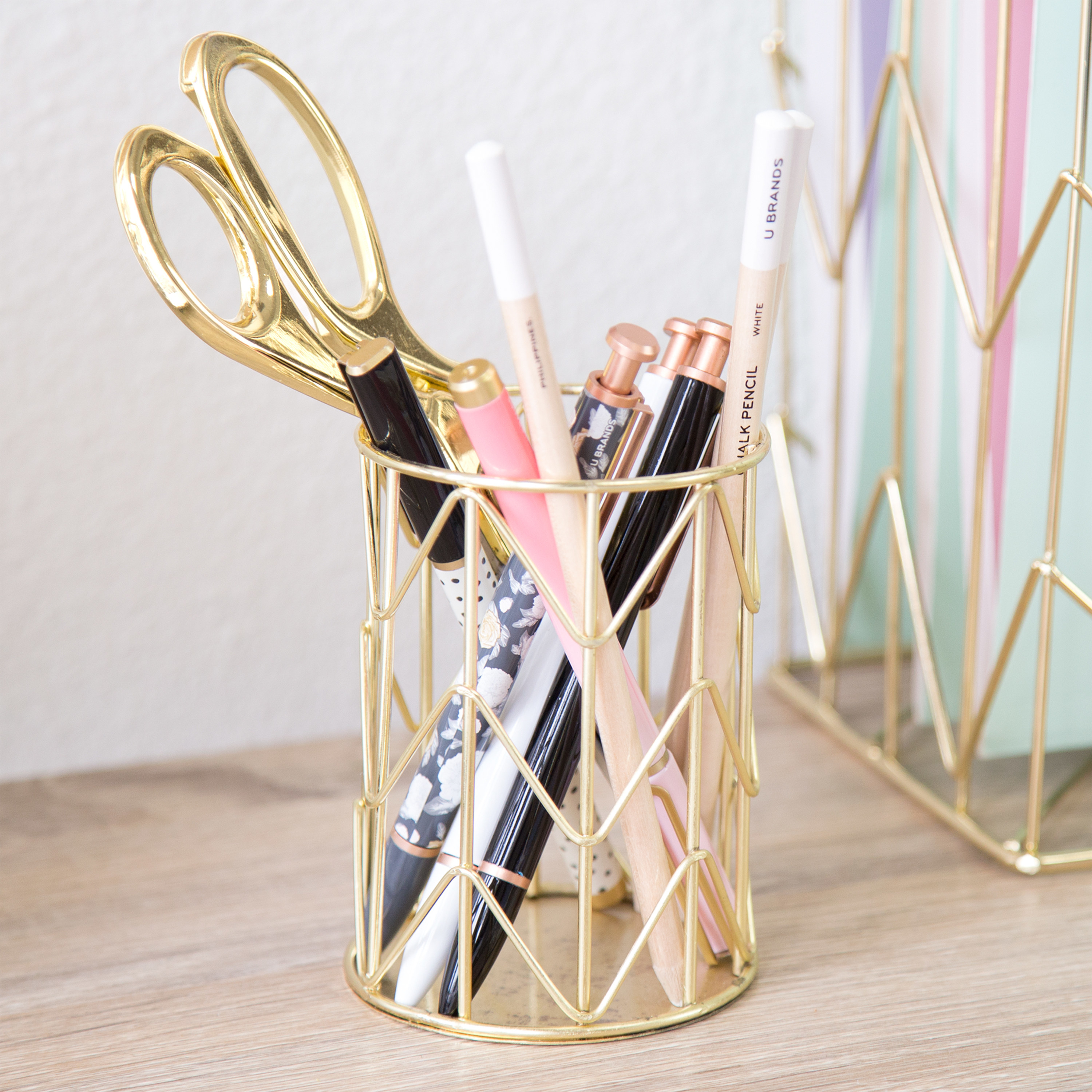 the pencil holder with office supplies in it