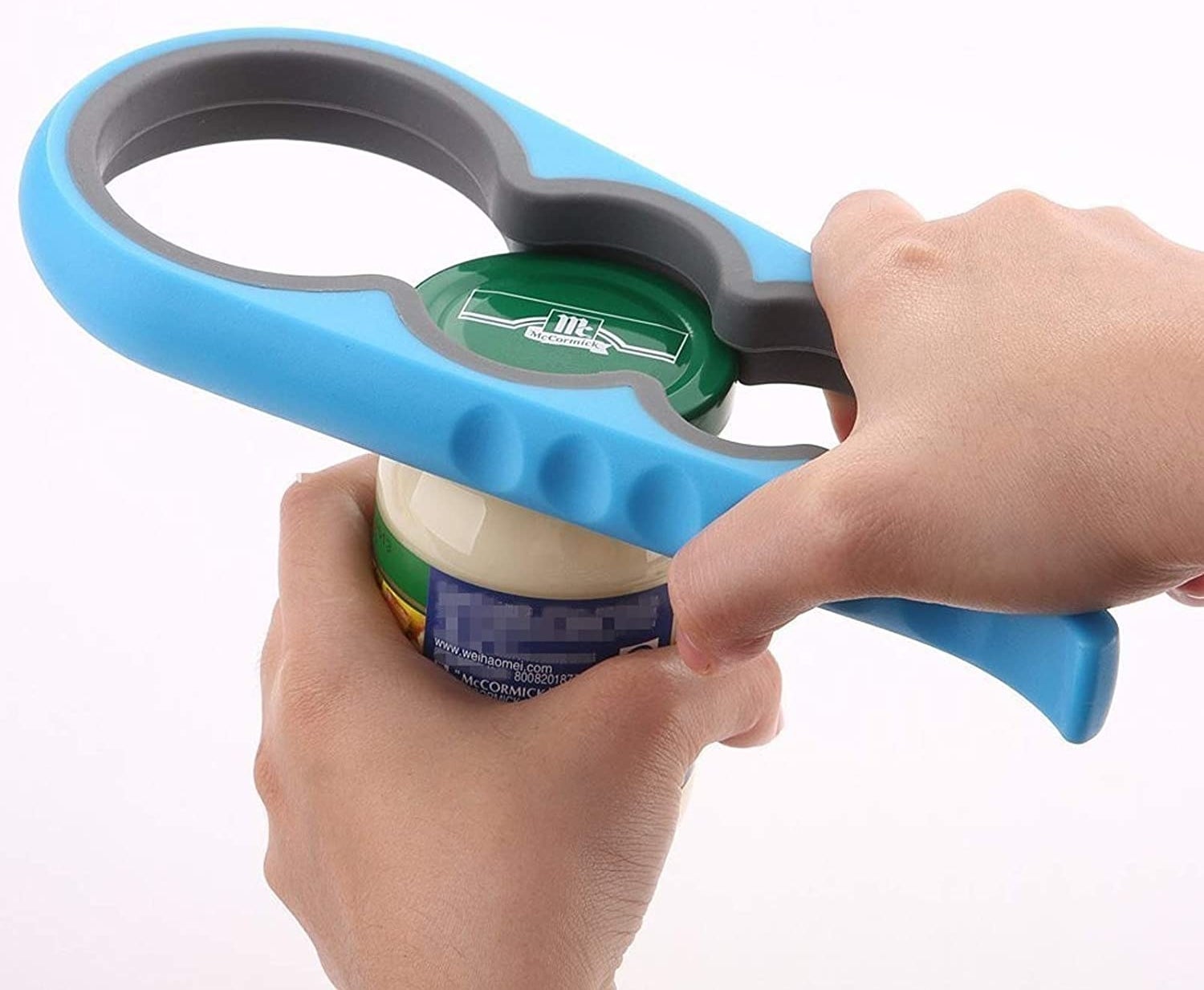 A person using the jar opening tool on a mayonnaise jar