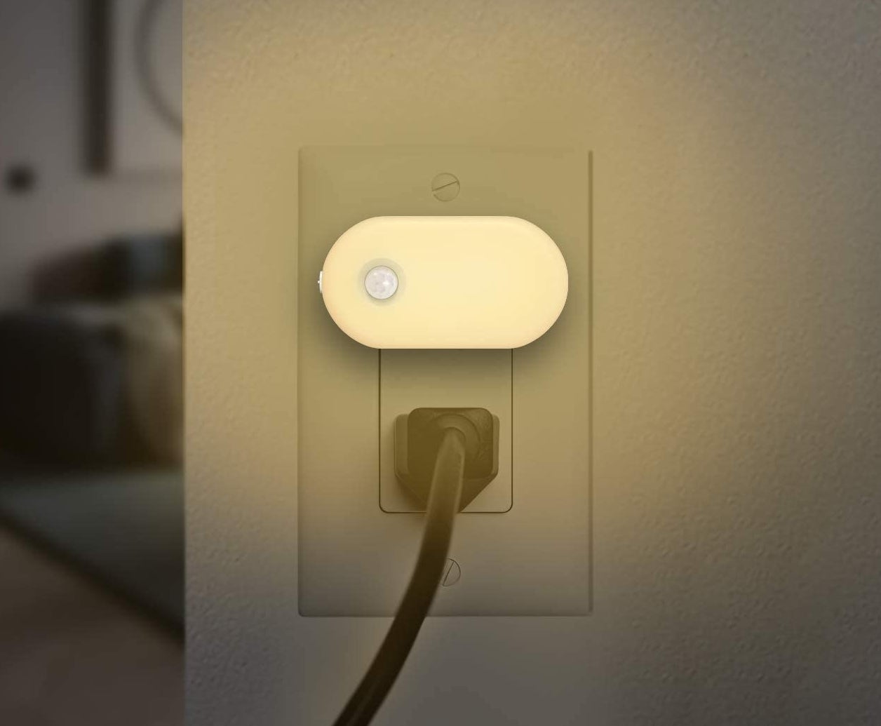 The motion sensor night light plugged into an AC outlet