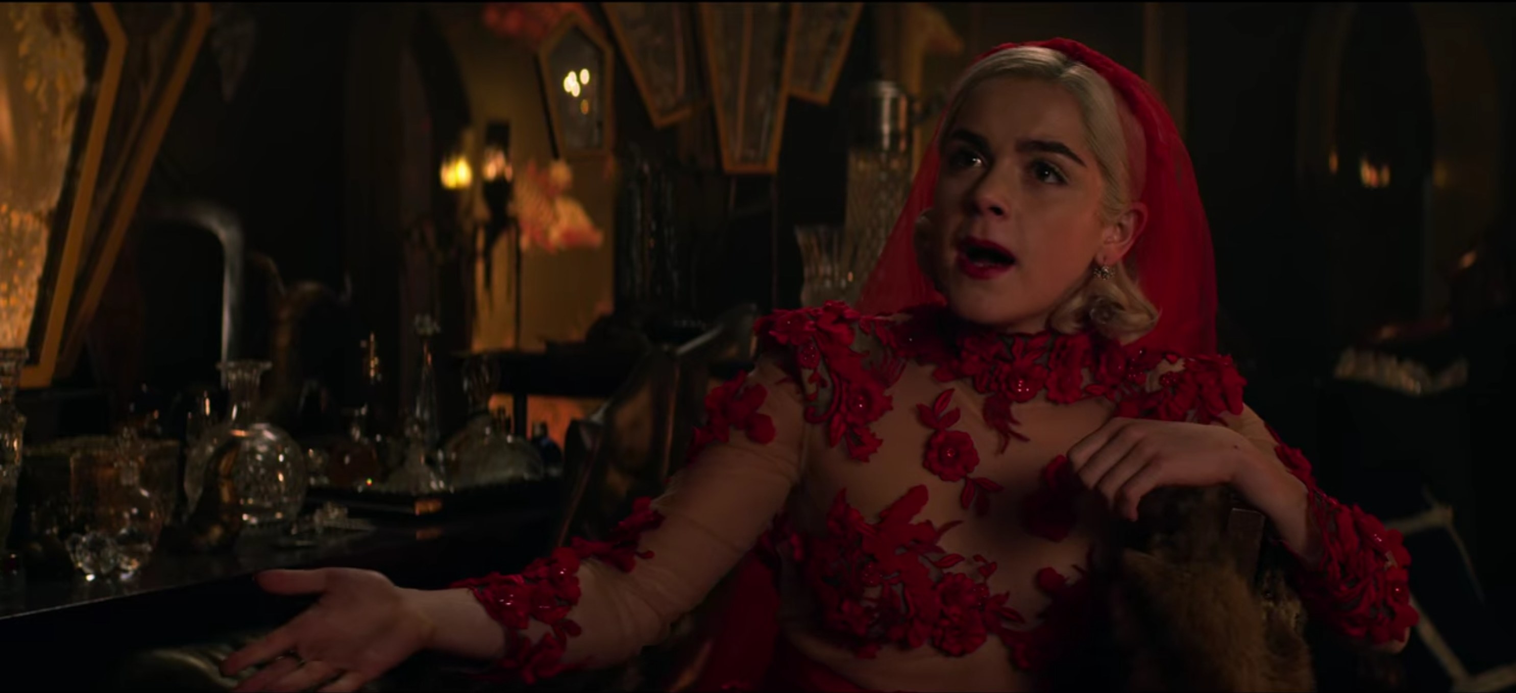 Sabrina in a red wedding dress and veil