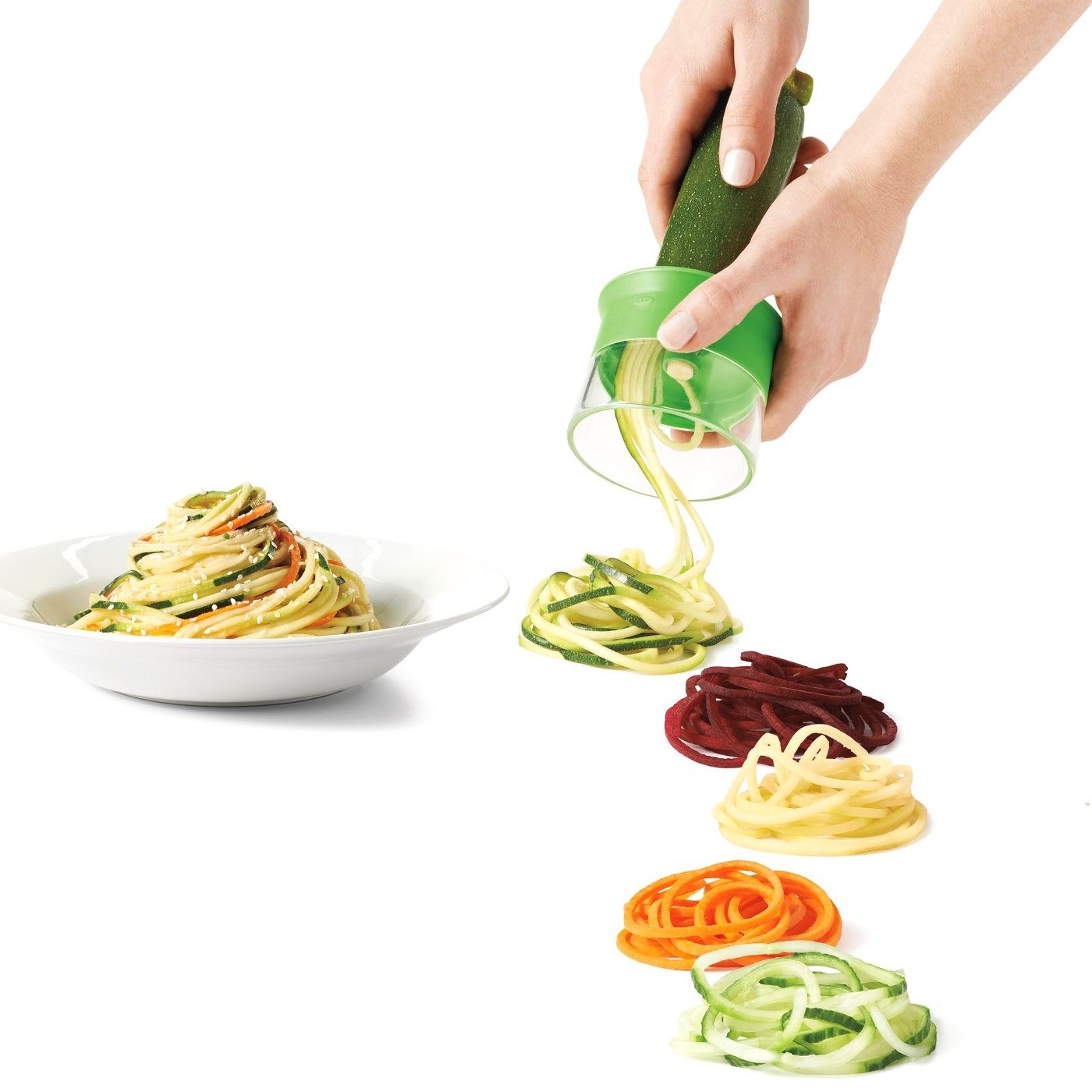 Hands using the spiralizer to make veggie noodles