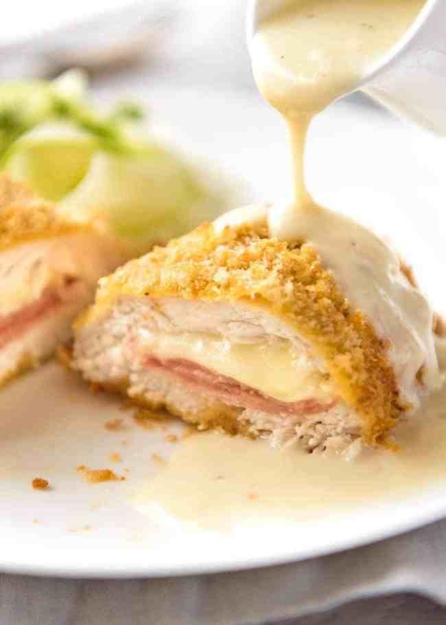 Breaded chicken Cordon Bleu covered in cream sauce.