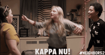 Girls chest-bumping and yelling, &quot;Kappa Nu!&quot;