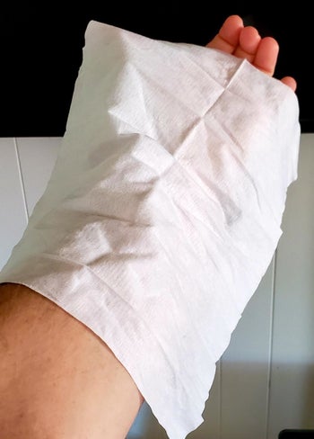 A reviewer's photo of them holding the XL wipe