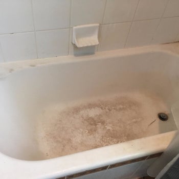 A reviewer's before photo with shows a tub with lots of staining
