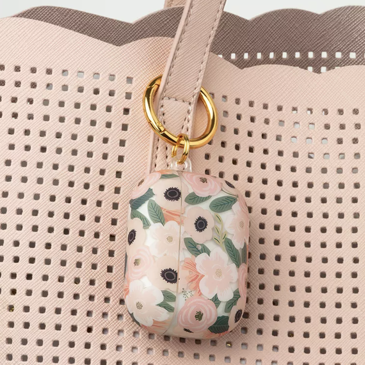 Floral Rifle Paper Co AirPods Pro case clipped onto handbag