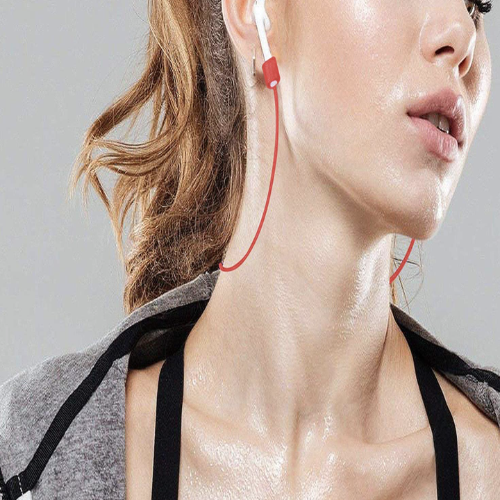 Model wearing AirPods with red strap attached