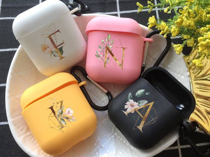 AirPods cases with gold monogram letters and floral prints