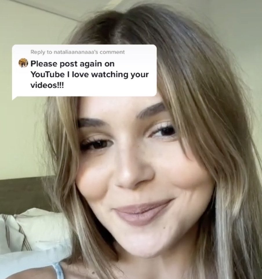 Olivia smiles next to a screenshot of a positive comment