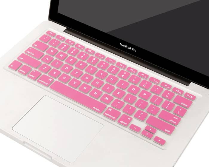 a pink cover on the keyboard of a macbook pro