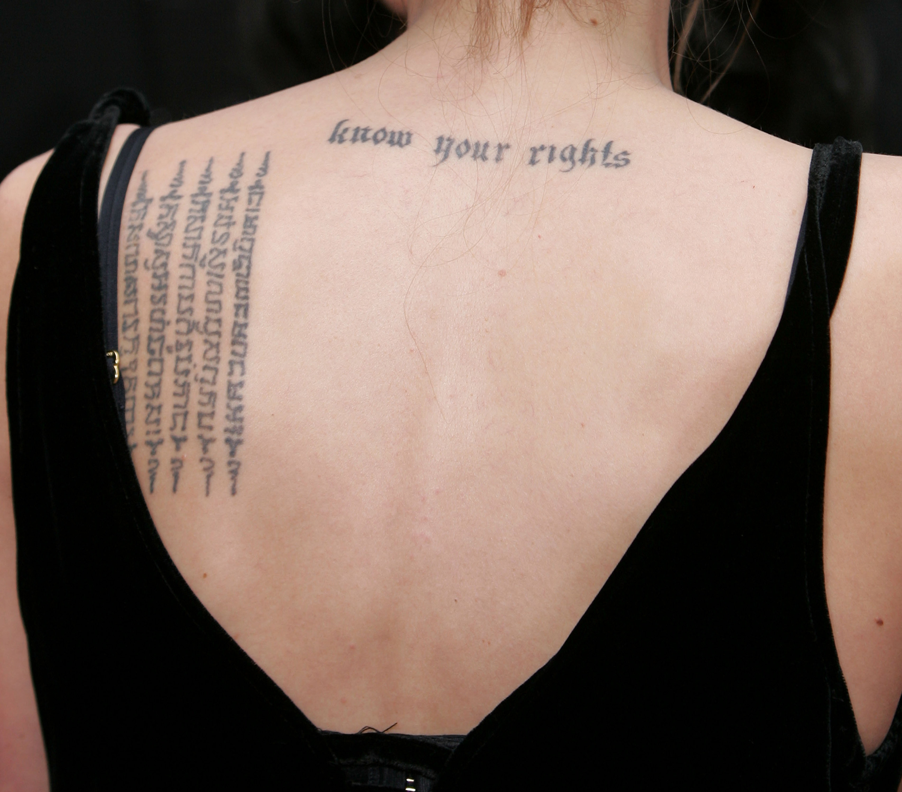 &quot;Know your rights&quot; on her back near the nape of her neck