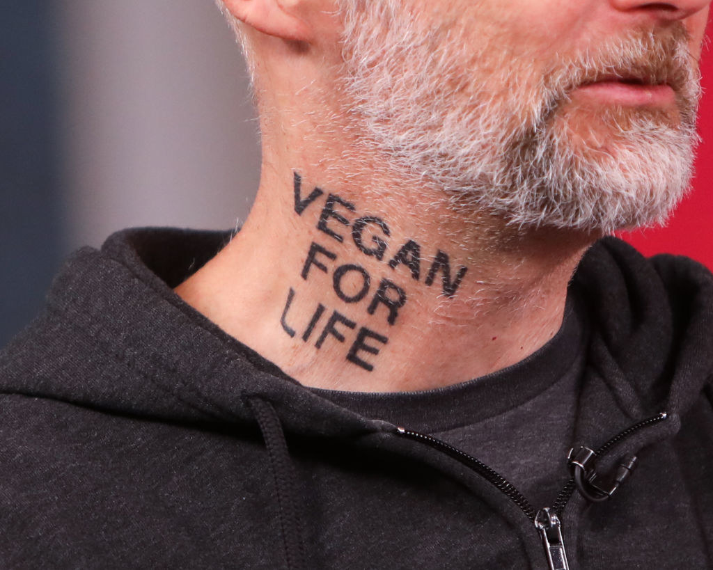 &quot;Vegan for life&quot; in all caps on the side of his neck