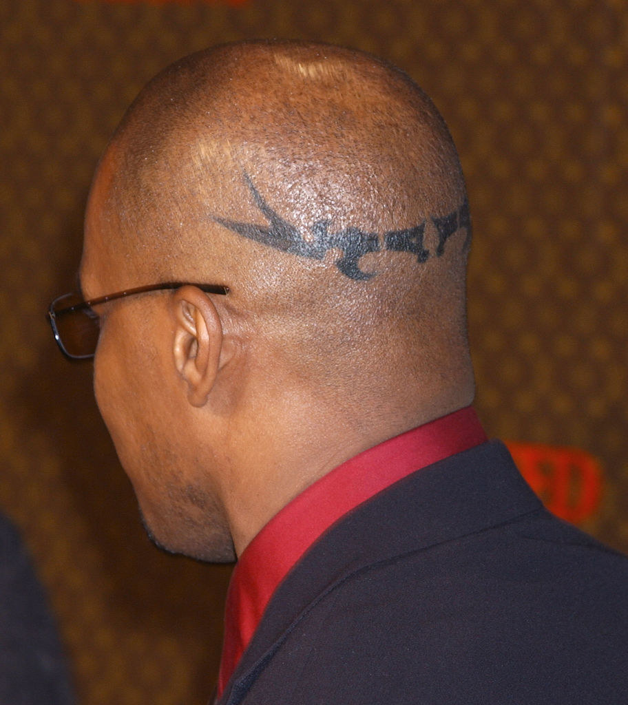 Jamie&#x27;s bald head showing the decorative horizontal tat on the back