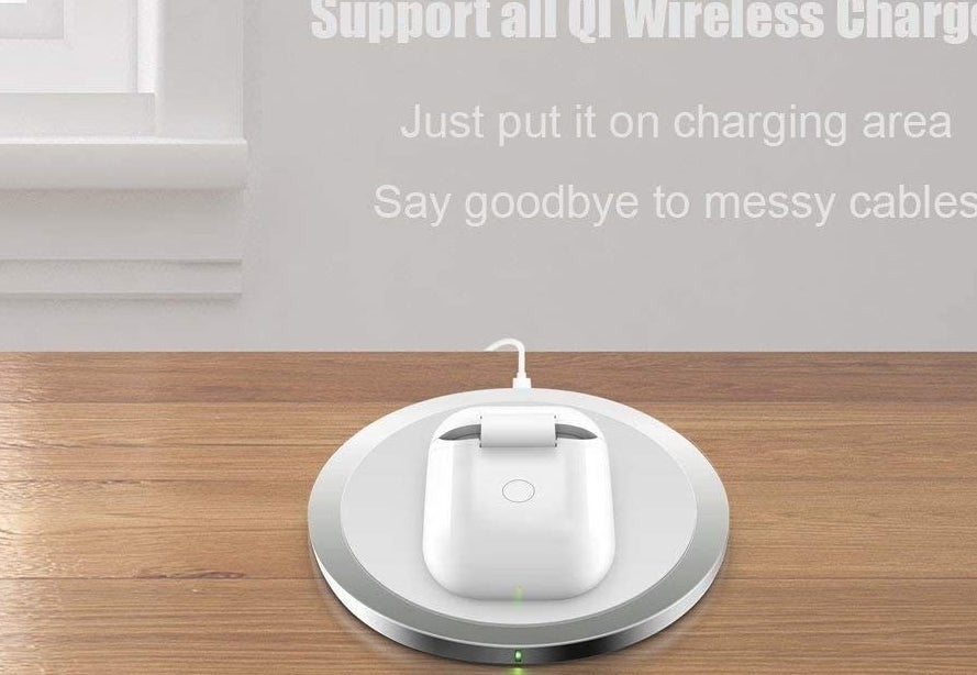 AirPods placed in wireless charger case on wireless charging pad