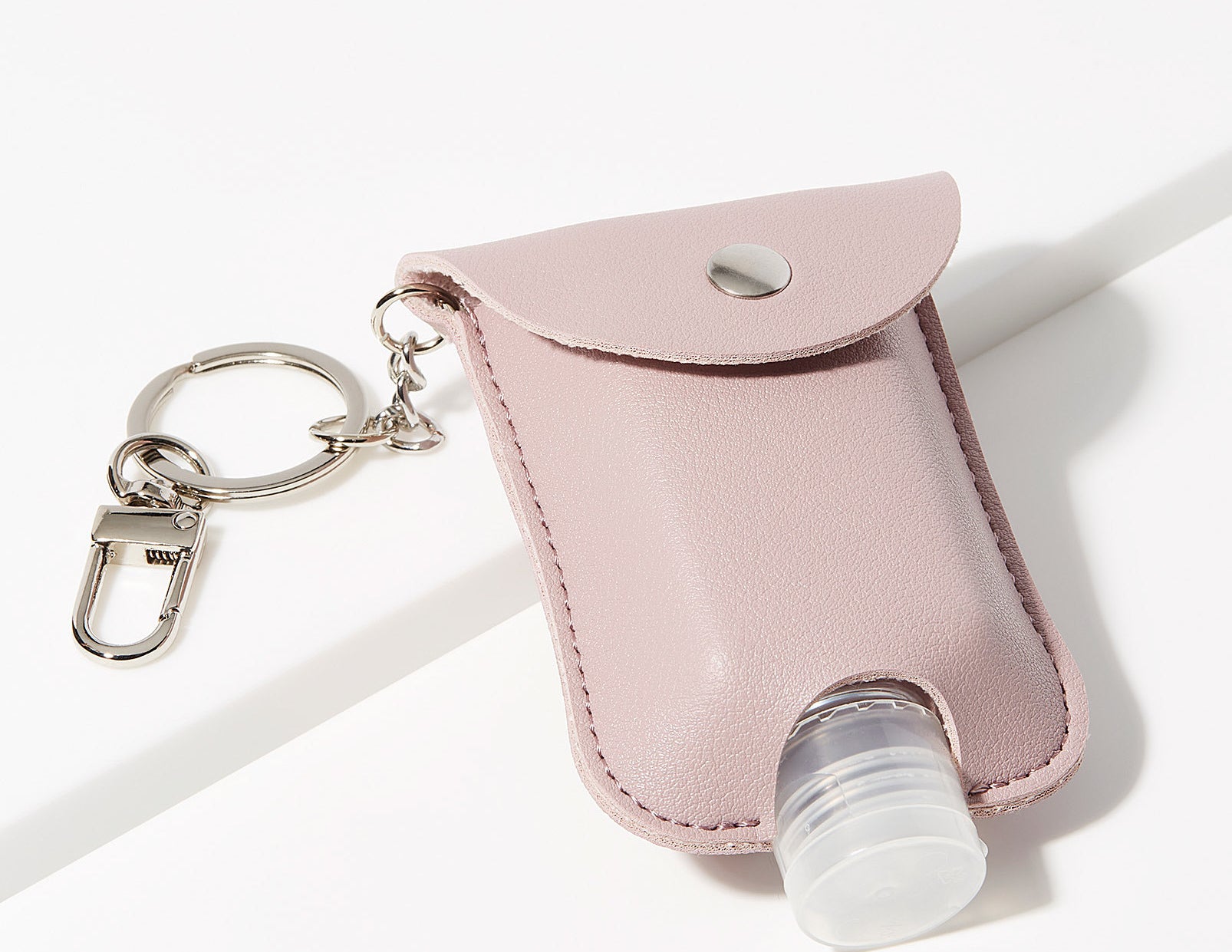 A small pouch with a hand sanitizer bottle in it