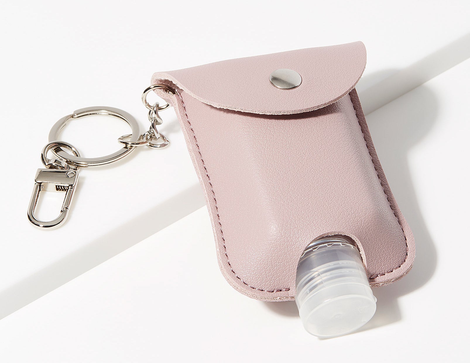 A small pouch with a hand sanitizer bottle in it