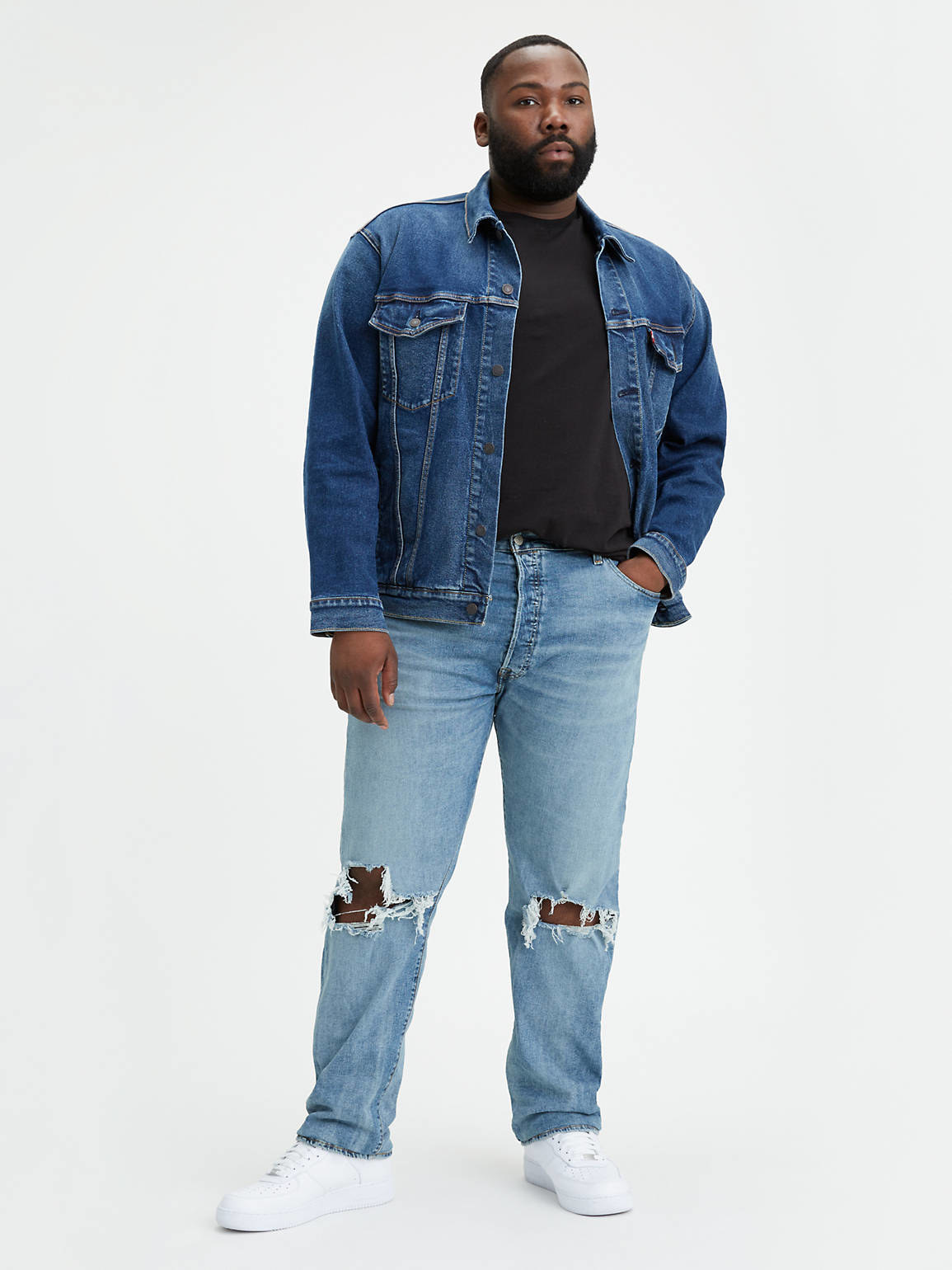 a model wearing the jeans which have a rip in the knee