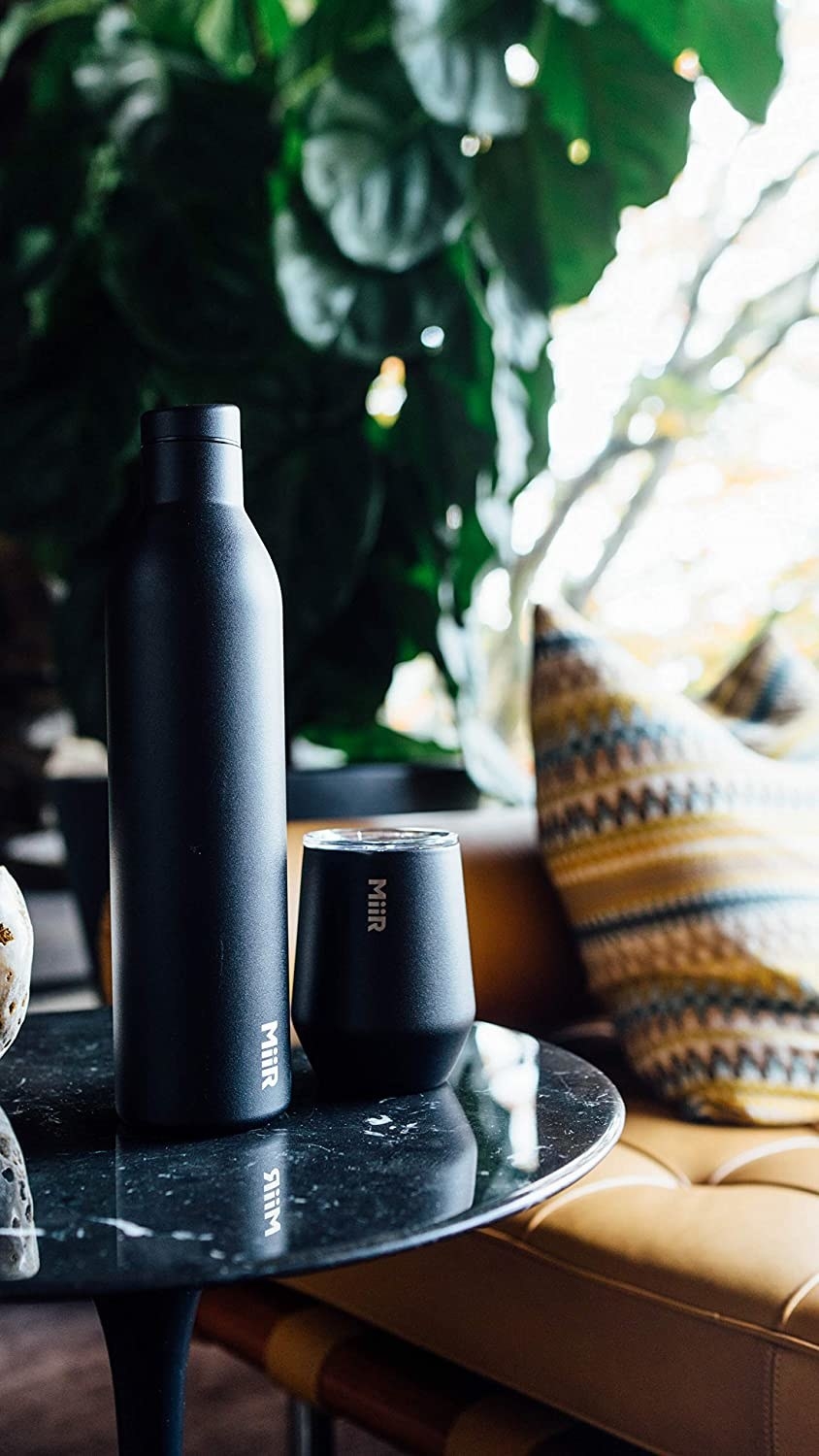 black miir wine tumbler and bottle on a side table