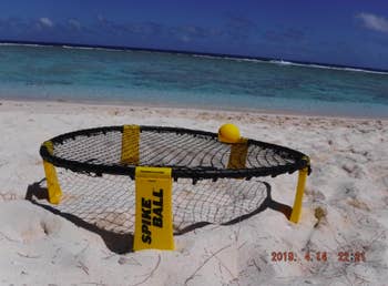 Another reviewer's round elevated net with ball in center placed in sand on beach 