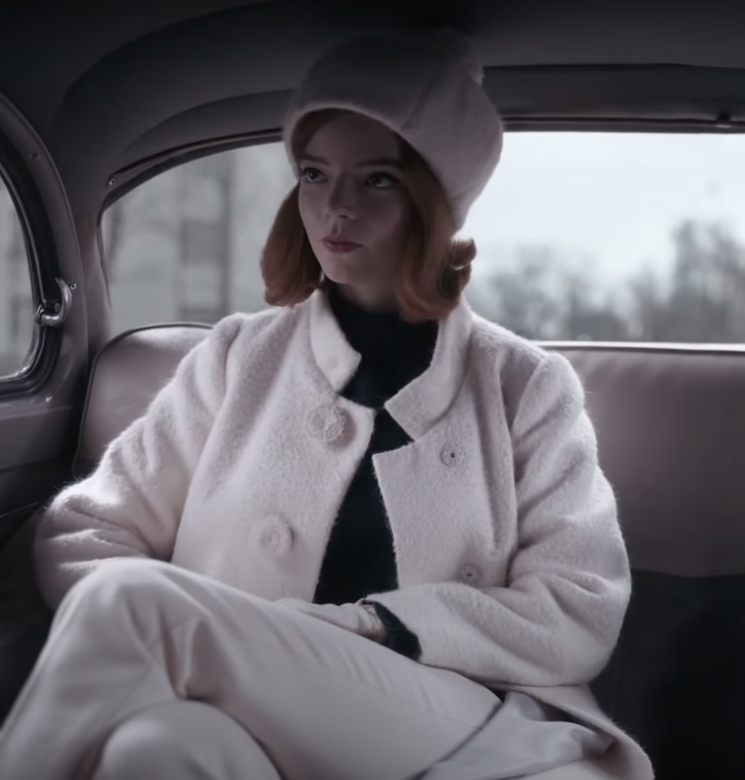 Beth on &quot;The Queen&#x27;s Gambit&quot; wearing a white coat, pants, and hat