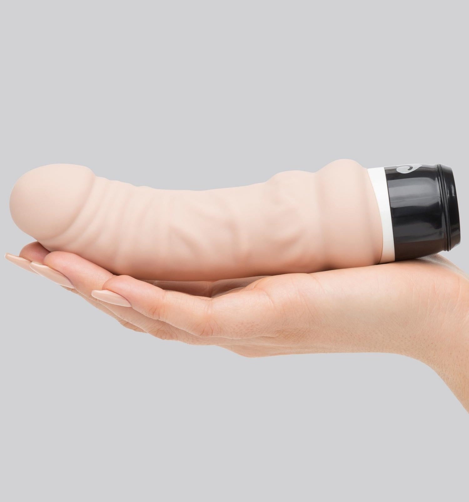 the Lovehoney Silicone 7 Function Mini Girthy Realistic Dildo Vibrator in a model&#x27;s hand