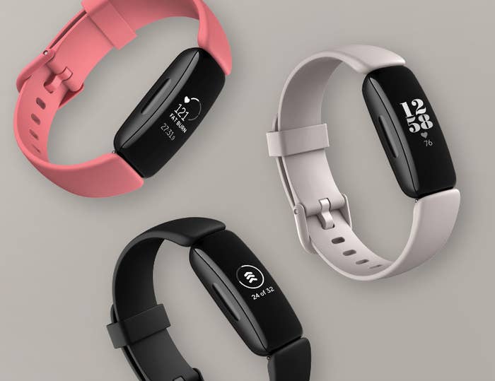 Three Fitbit Inspire health trackers in three colours 
