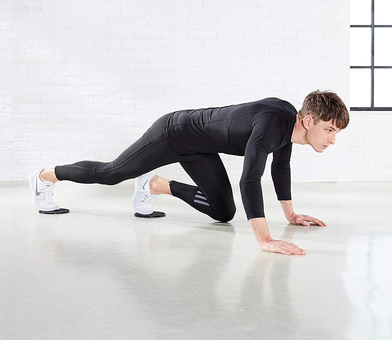 A person on all fours, with the sliders under their feet