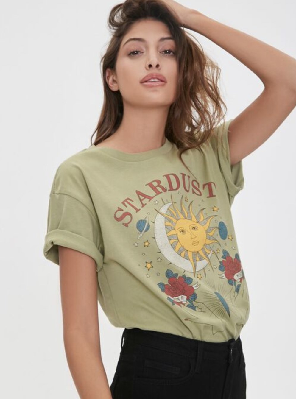 Model is wearing a pale green graphic tee and black jeans