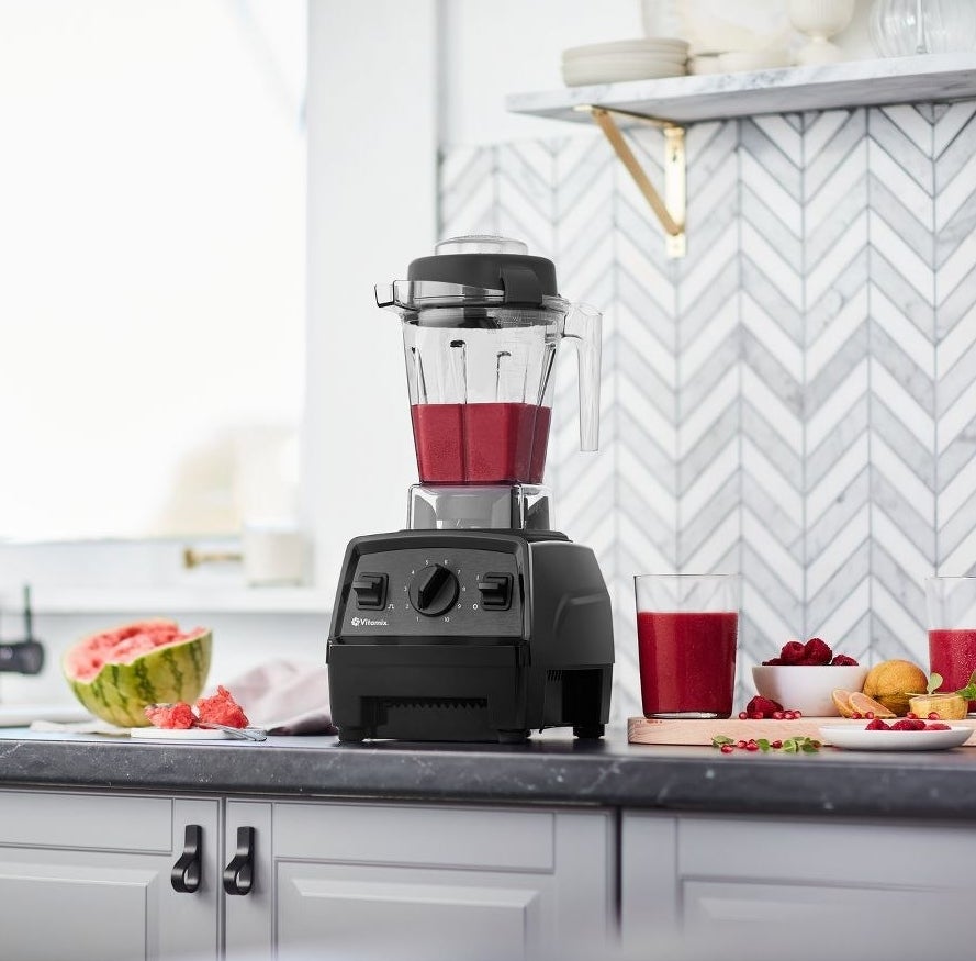 black vitamix blender with a fuchsia smoothie inside of it