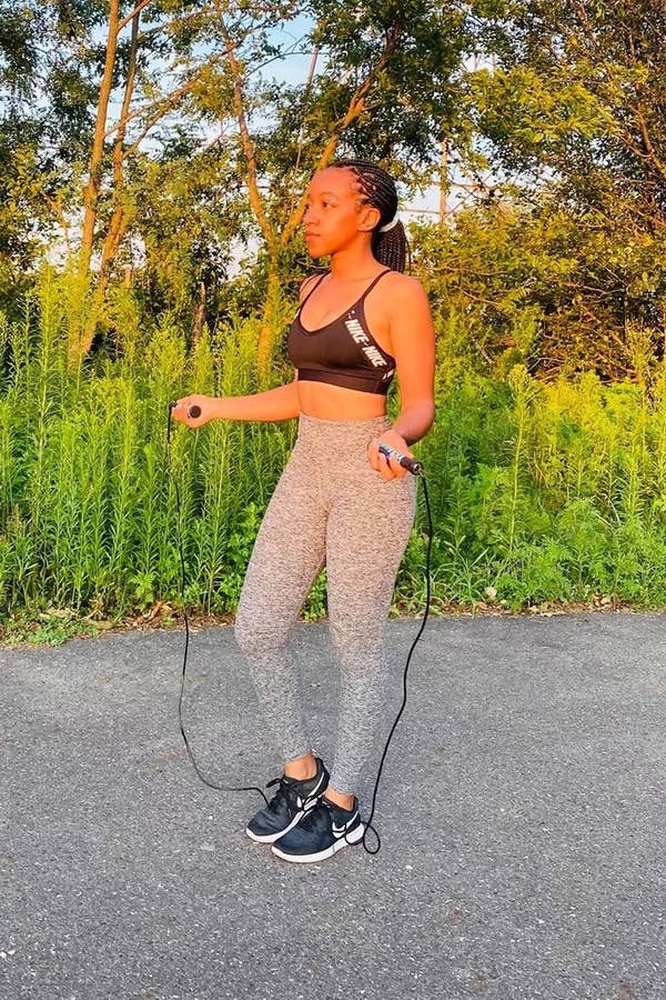 Person standing while holding extra thin jump rope 