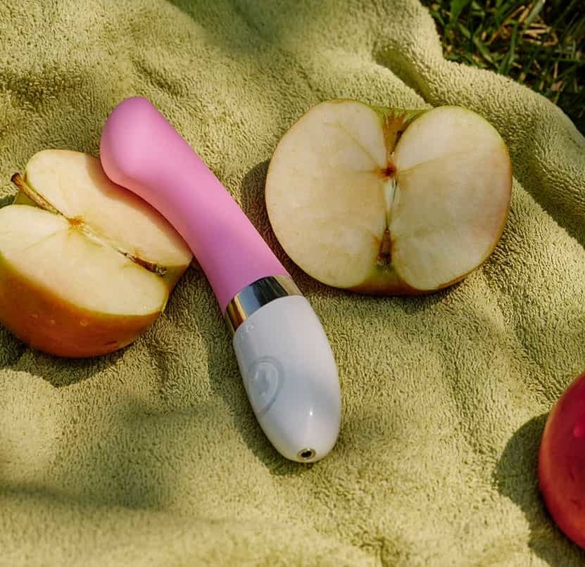 Pink Lelo Gigi 2 G-spot stimulator next to apple halves