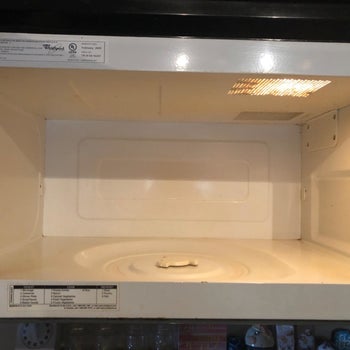 The reviewer's after photo which shows all the spots are gone and the microwave is clean