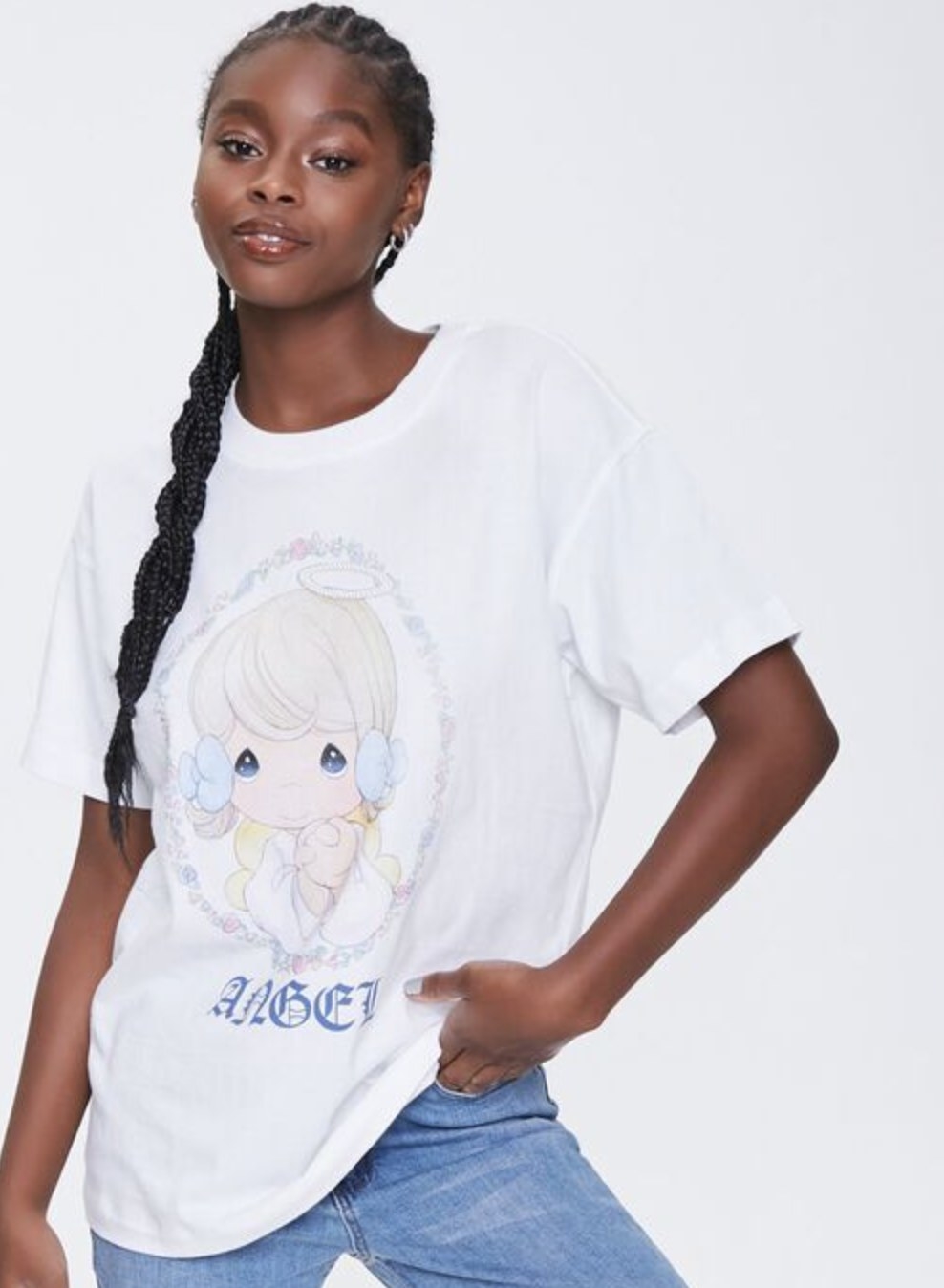 Model is wearing a white graphic tee of an angel and blue jeans
