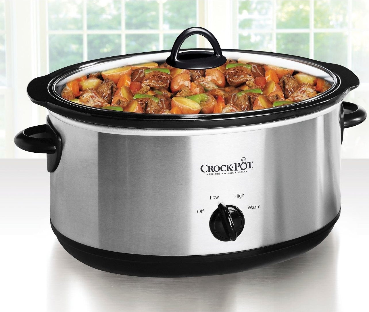 sliver crockpot cooking a stew while on a kitchen counter