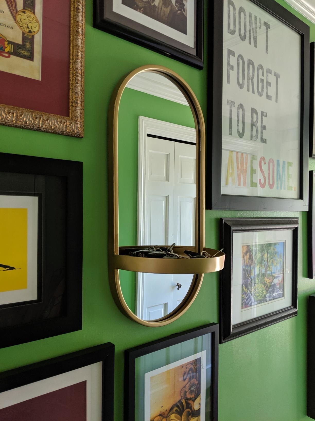 reviewer image of the gold kate and laurel modern metal wall mirror with shelf