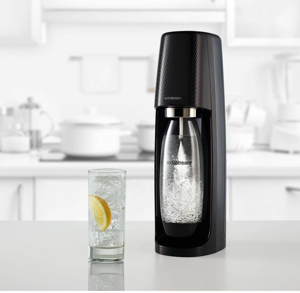 black sodastream machine making sparkling water on a kitchen counter