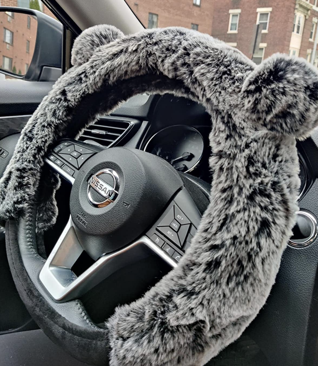 reviewer photo of the gray bear cover on steering wheel