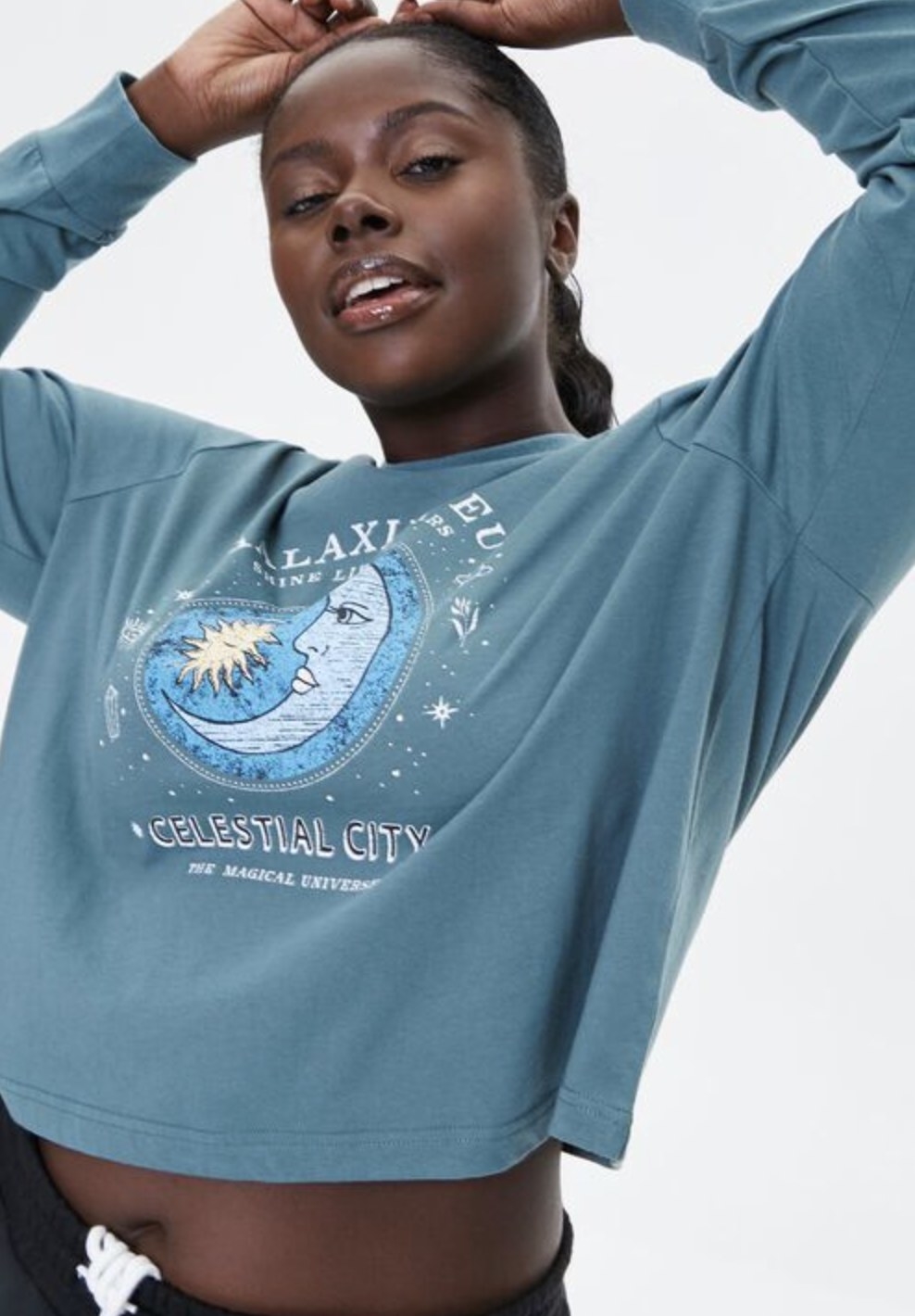 Model is wearing a pale blue sweatshirt