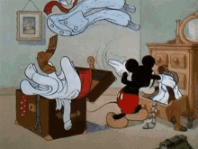 Mickey Mouse looking for something in a drawer