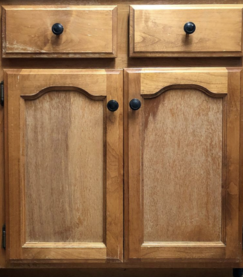 a reviewer's wooden cabinets looking worn out