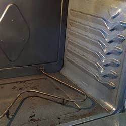 the same reviewer's oven looking cleaner after using the spray
