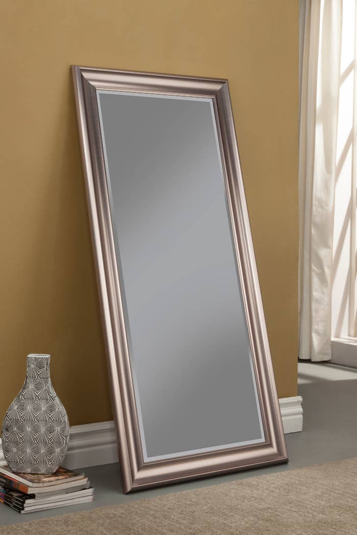 The mirror, which is long and rectangular, in rose-gold frame