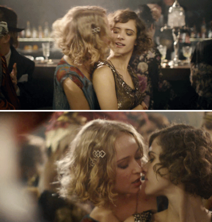 Charlotte and Greta kissing at a bar