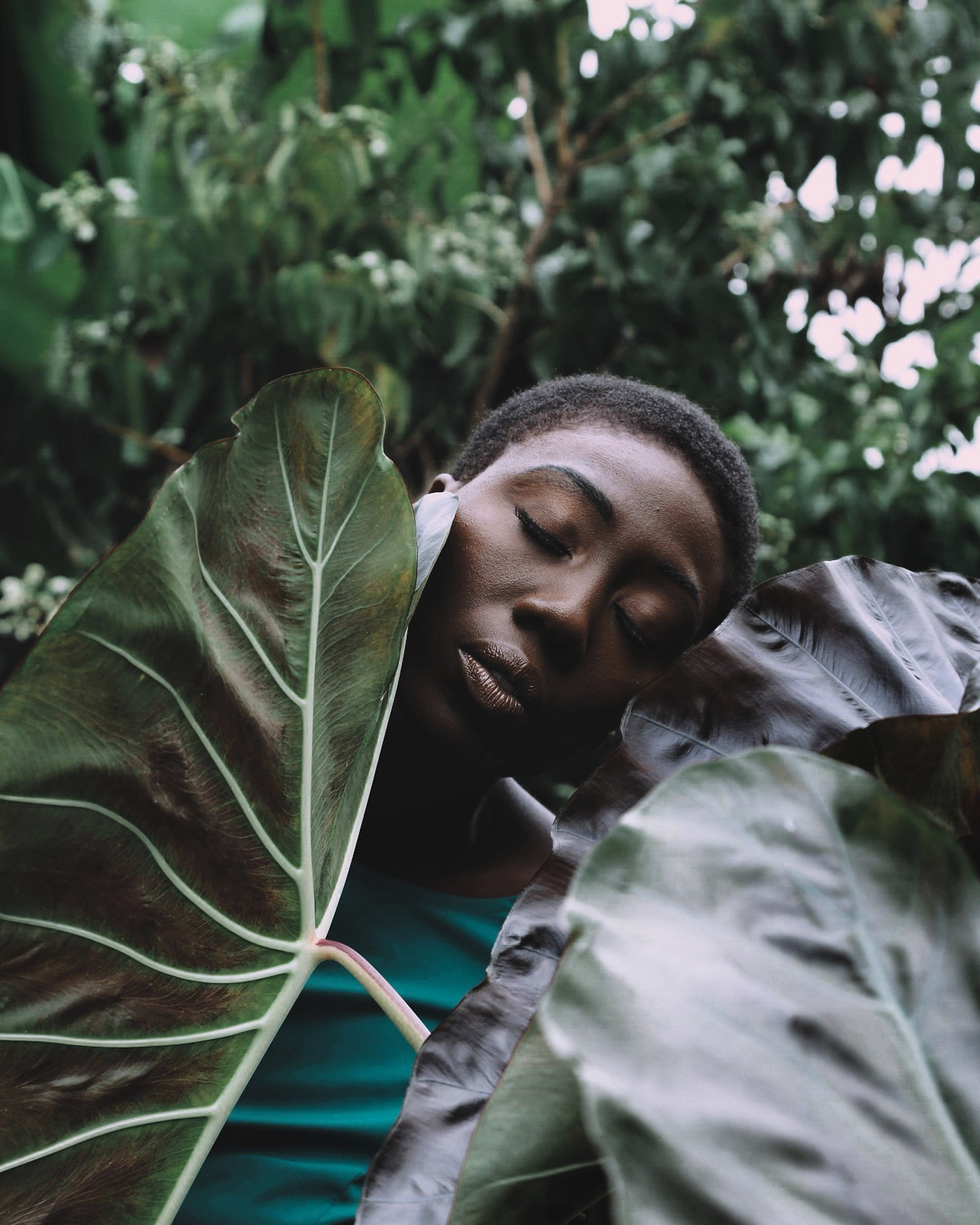 A Black model surrounded by plants