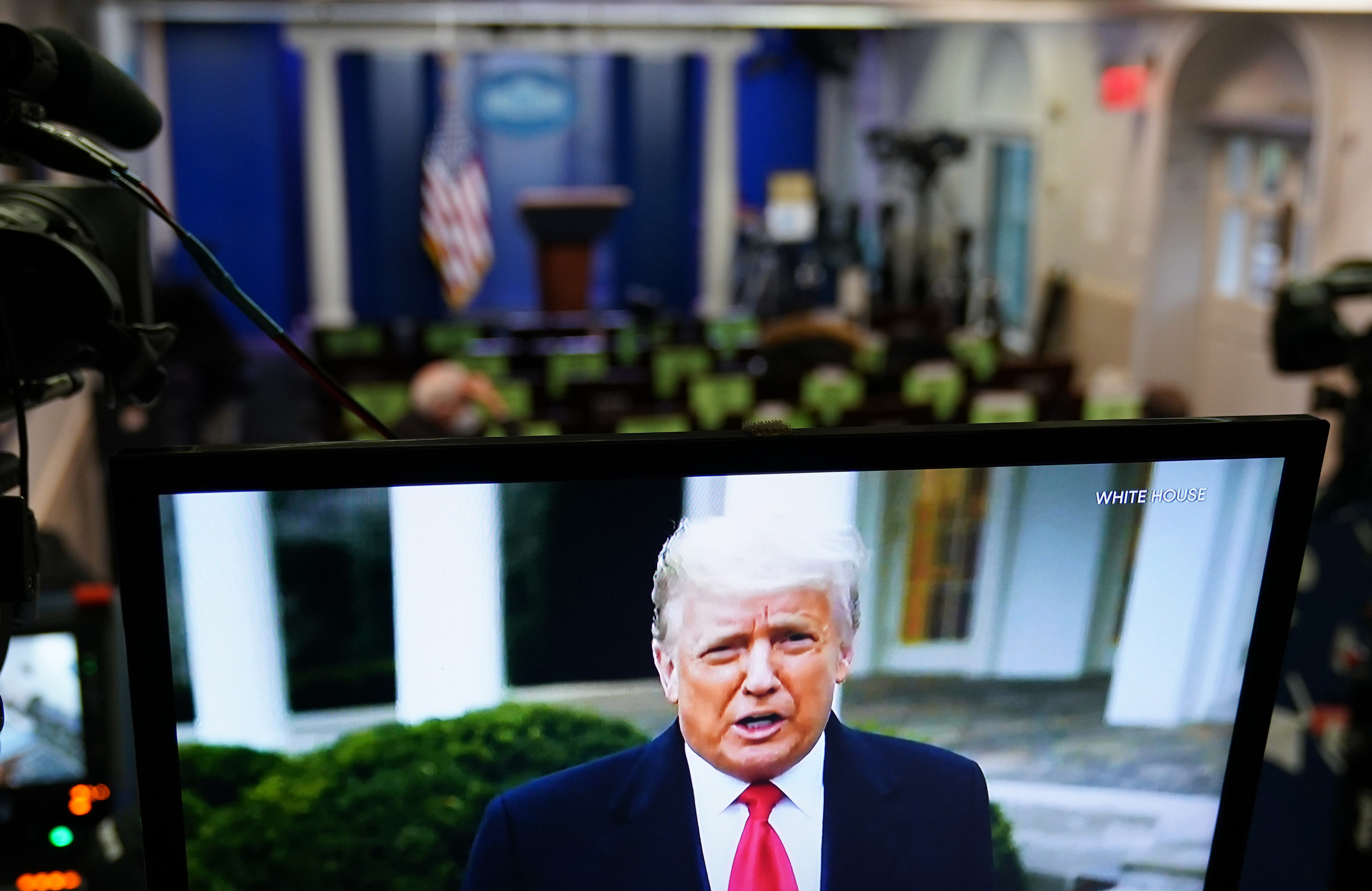 President Donald Trump is seen on a TV in the White House&#x27;s press briefing room